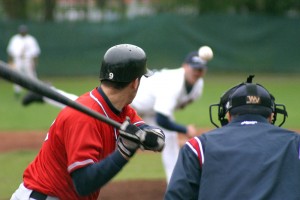 Baseball player swinging at pitch