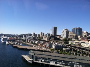 Seattle glistens under blue skies on a recent summer day. More sunshine is in store this week, with temperatures climbing into the mid 80s Tuesday.